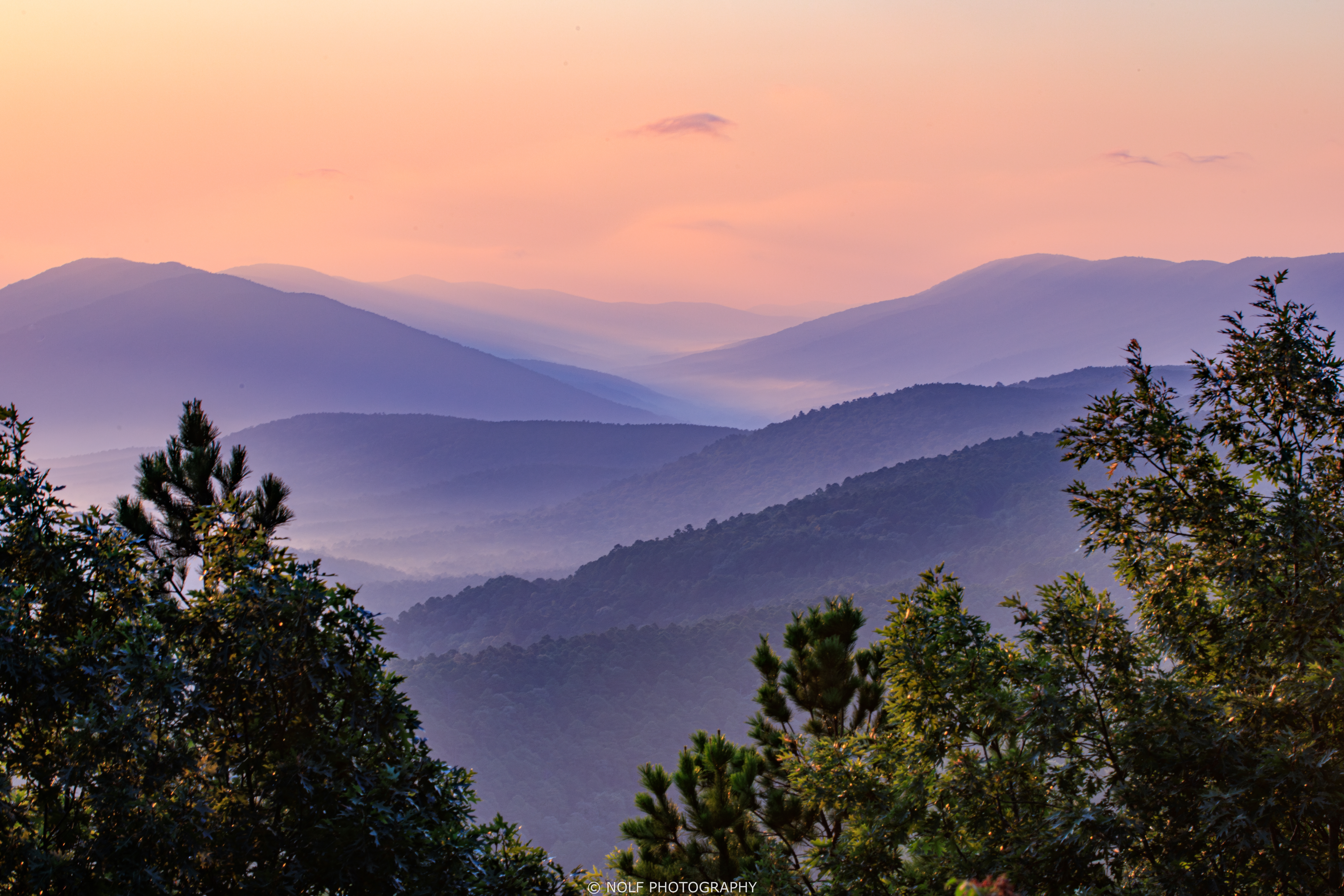 Welcome back to #PhotoOfTheWeek Friday, friends! Summer seems to have let its intense grip slip in the past week, and we don't mind it. We have a special one today from photographer Ryan Nolf. The Talimena Scenic Byway is one of the prettiest destinations around, and especially at the stunning Emerald Vista. It might look like an enchanted land from folklore, but southeast Oklahoma proves that sometimes reality can be as good as fiction.