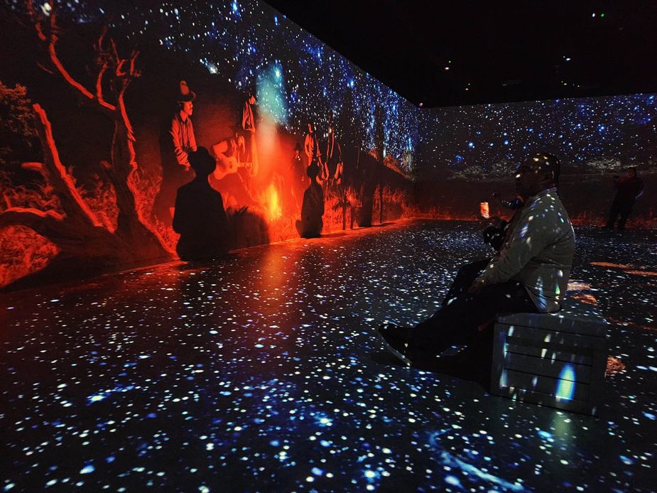Visitors sit under the simulated stars at The Cowboy: An Immersive Journey. Photo by Megan Rossman