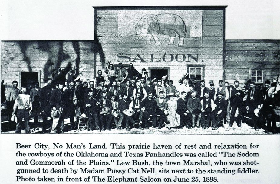 Beer City came to be known as the “Sodom and Gomorrah of the Plains.” In this photo taken in front of Beer City’s Elephant Saloon on June 25, 1888, the town’s self-appointed sheriff, Amos Bush, sits next to the fiddler at the right of the photo. Local businesswoman Pussy Cat Nell and a posse of fourteen men later shot Bush to death. Western History Collections/University of Oklahoma