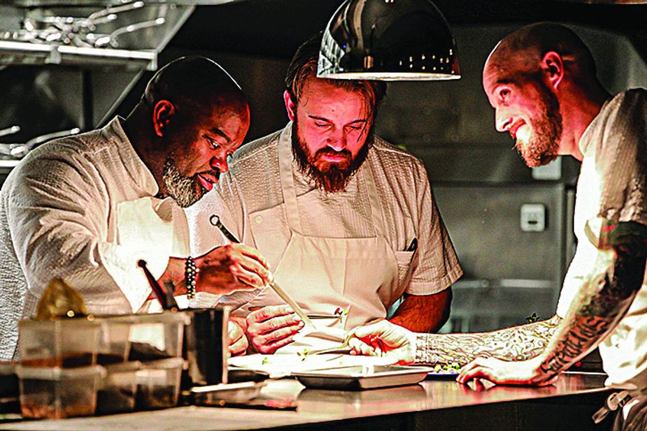 Chef Andrew Black, left, works with his crew at Grey Sweater