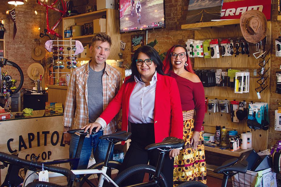 Capitol Co-Op owner Chad Hodges; Gloria Torres, executive director of Calle dos Cinco in Historic Capitol Hill; and Kristin Hoover Gentry at Capitol Co-Op, a local institution that’s one part bike shop and one part coffeehouse. Photo by Zoe Elrod