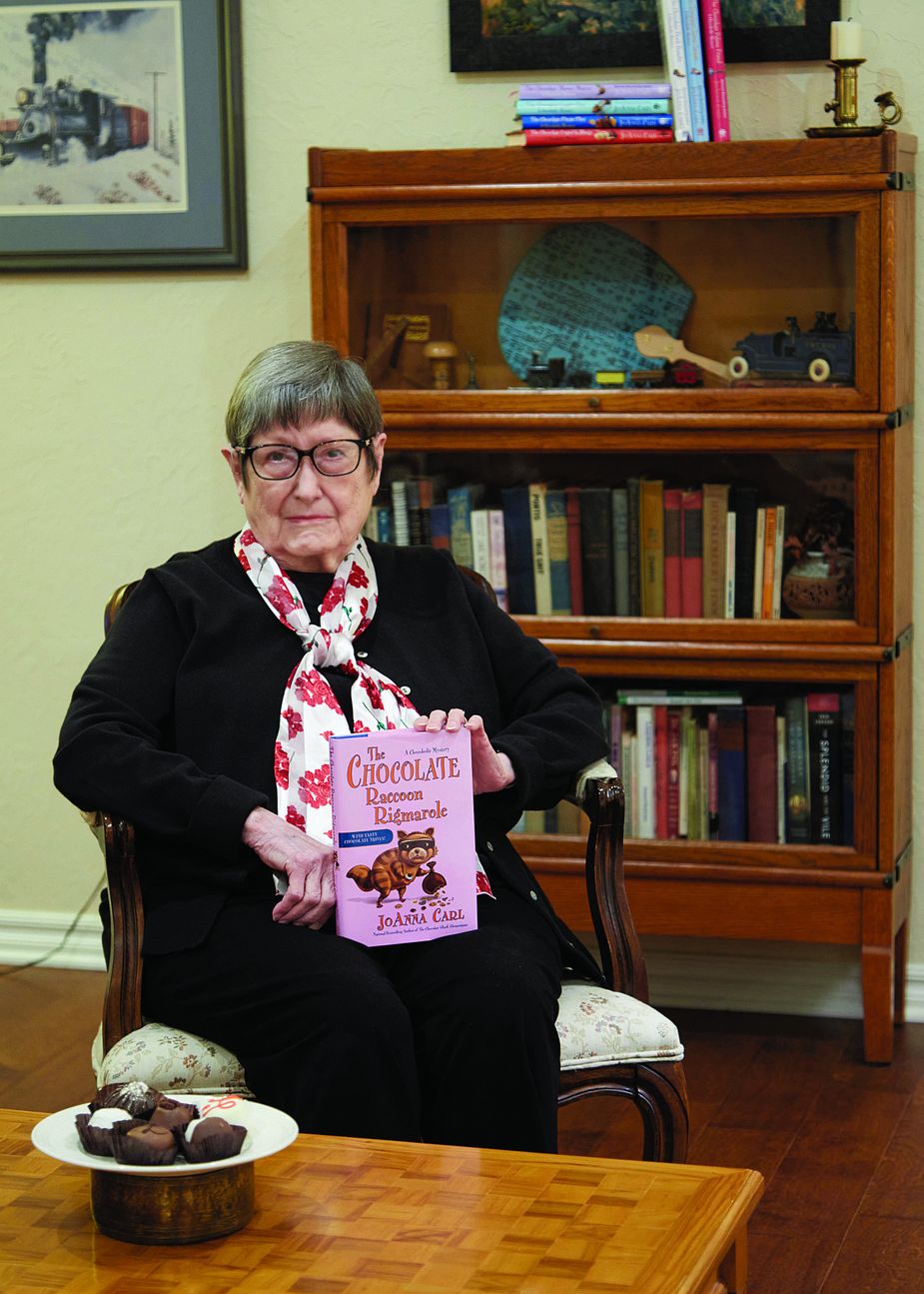 Author Eve K. Sandstrom, often known by her pen name JoAnna Carl, with her latest book. Photo by Mike Mazzo