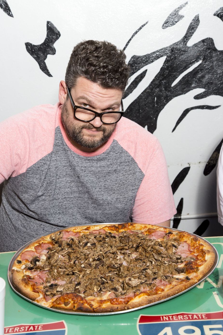   If the six-pound pizza challenge at Papa Angelo's in Bethany, seen here taunting Greg, isn't your style, the downtown restaurant also is a great place for a slice. Photo by Lori Duckworth