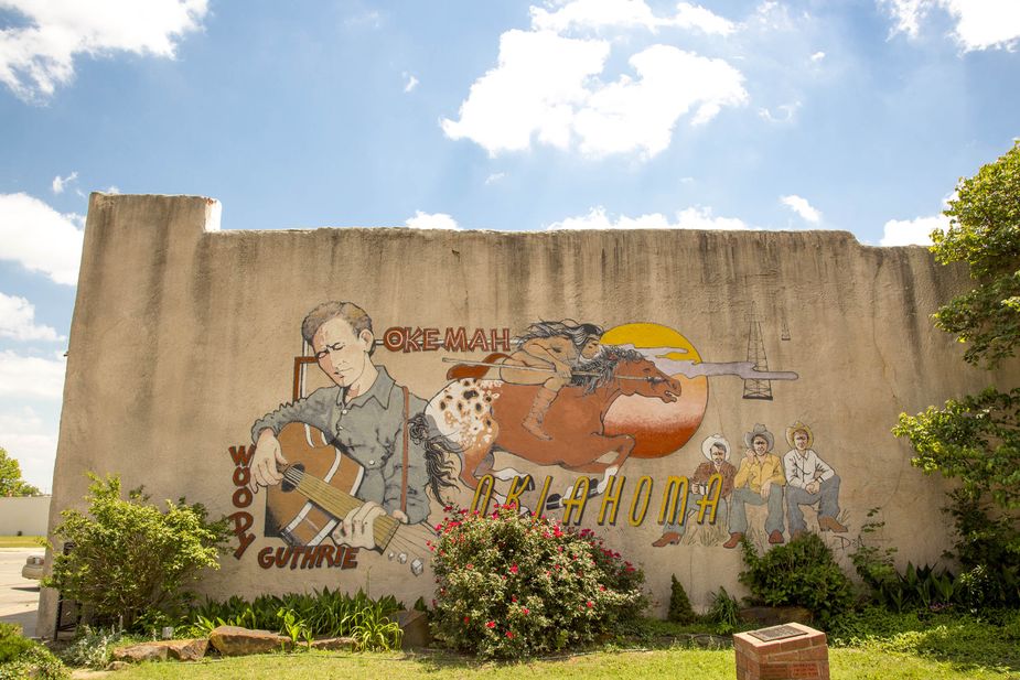 A Woody Guthrie mural and nearby statue in downtown Okemah pay homage to the iconic musician. Photo by Lori Duckworth