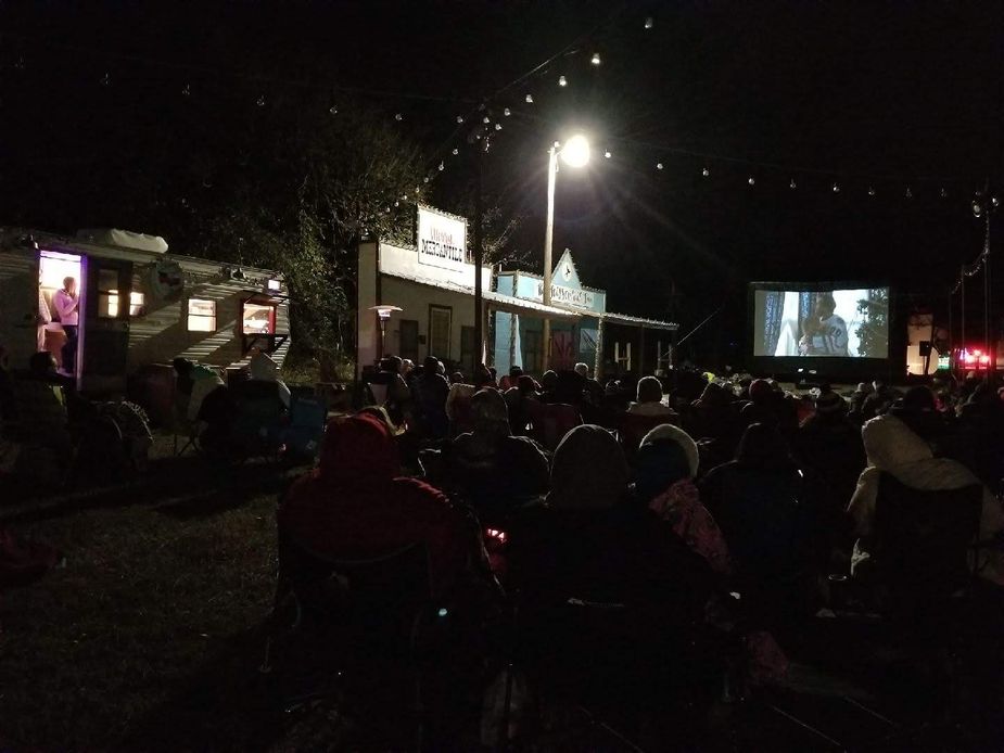 Crowds gather for an outdoor movie at the Wells Family Christmas Tree Farm in Norman.