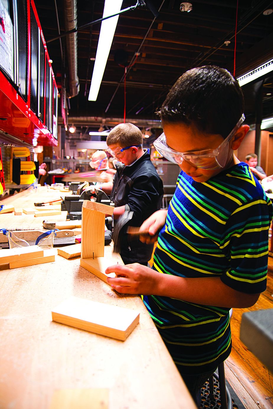 Future carpenters can practice woodworking in safety at Leonardo's Tinkering exhibit. Photo by Kim Baker