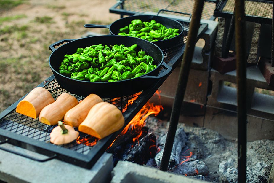 Living Kitchen Farm & Dairy incorporates outdoor cooking into its dinners at the Depew farm, where meals are served in a rustic-but-elegant country cabin setting. Photo by Valerie Wei Haas