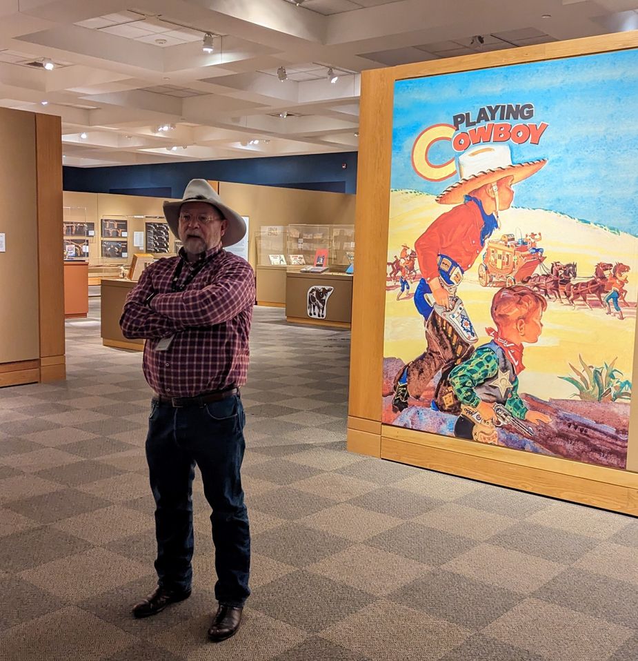 Curator Michael Grauer gives a tour of the new "Playing Cowboy" exhibit at the National Cowboy and Western Heritage Museum in Oklahoma City. Photo by Greg Elwell