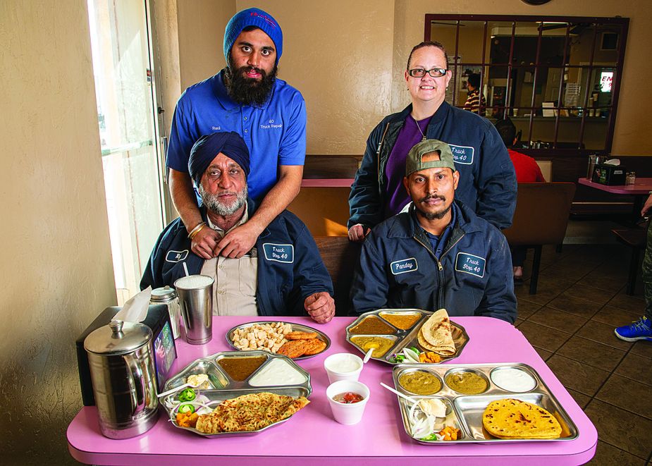 Clockwise, from top left: manager Rahul Singh, assistant manager Shannon Sexton, senior mechanic Parbhaker Pandey, and owner Raj Singh help their customers with more than hunger.