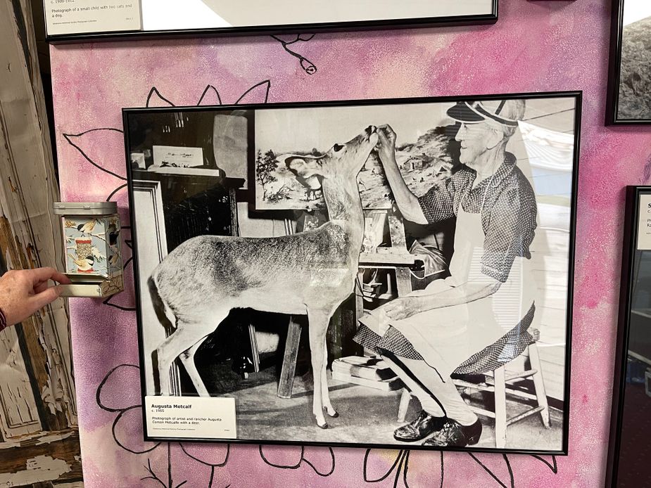 This photo of August Metcalf feeding a deer hangs inside the Rural Oklahoma Museum of Poetry. Photo by Nathan Gunter
