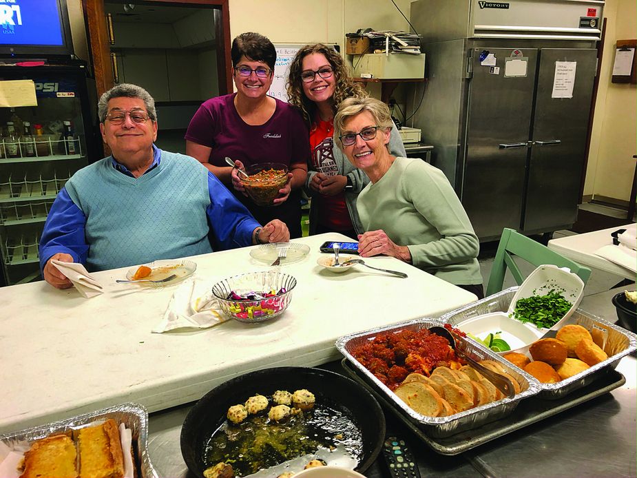 The Slyman family—Ed, Dava, Kady, and Sherian—enjoy a meal in the Freddie's Bar-B-Que & Steak House kitchen. Photo by Brent Fuchs