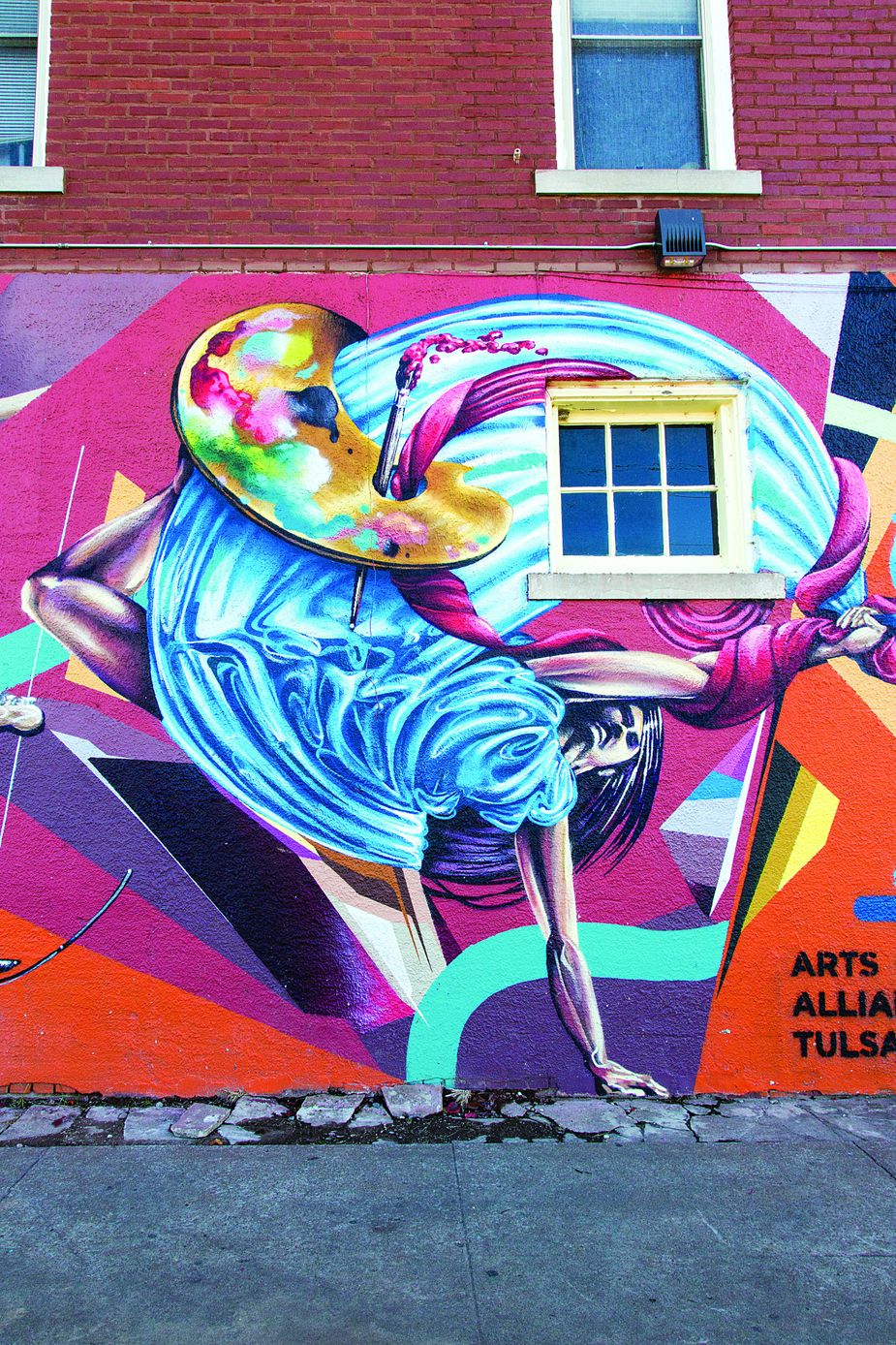 Yatika Starr Fields and Codak Smith collaborated on this mural outside of the Hunt Club in the Tulsa Arts District.
