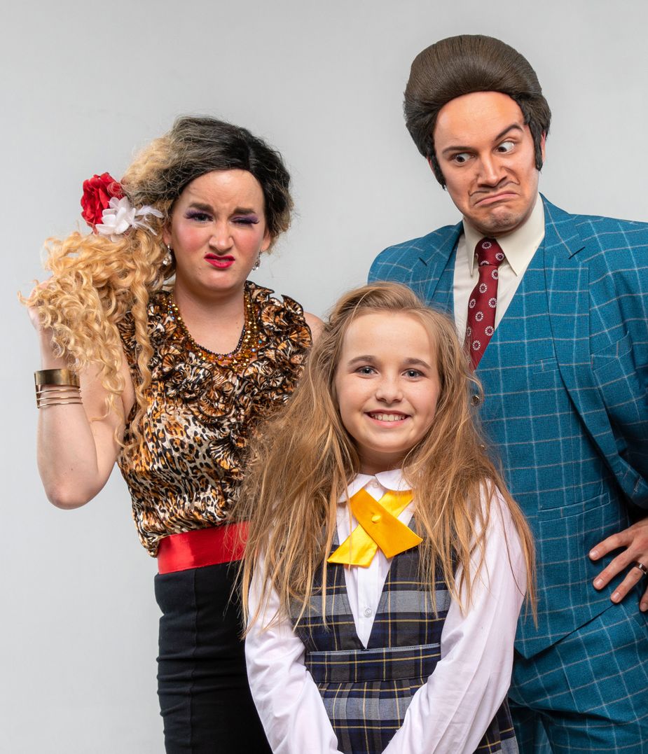 Matilda, played by Gigi Jenkins, with Mr. and Mrs. Wormwood (Travis Guillory and Claire Schroepfer) take the stage in Theatre Tulsa's show "Matilda the Musical." Photo by Josh New Photography