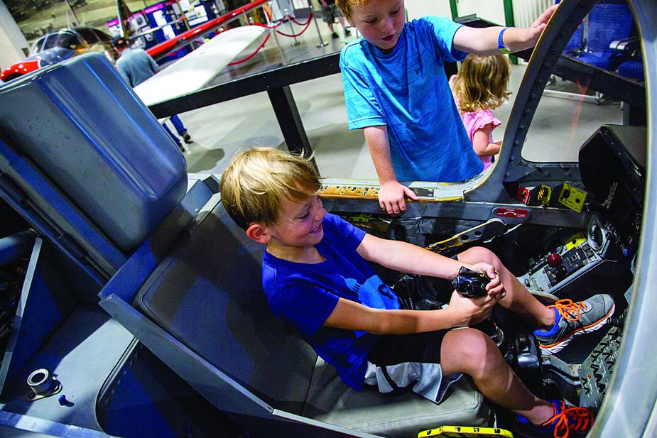 Kids can get a feel for the pilot's seat safely on the ground at the Tulsa Air and Space Museum complex. Photo by Lori Duckworth