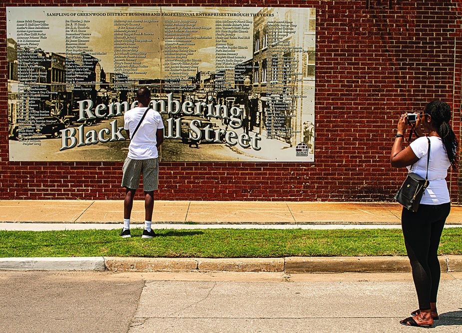 A sign commemorates many of the businesses that have operated in the district. Photo by Shane Bevel