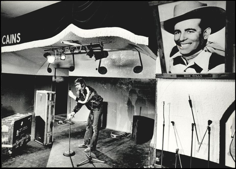 Former owner Larry Shaeffer sets up a mike on the Cain’s stage in November 1979. Photo courtesy Oklahoma Historical Society