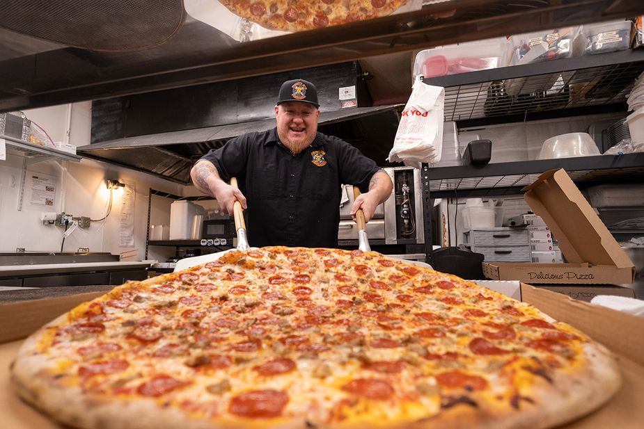 Other pizzas might cower in fear at the might of Heavy D’s 28-inch behemoths—if each oversized slice didn’t disappear into customers’ mouths so quickly. Photo by Lori Duckworth