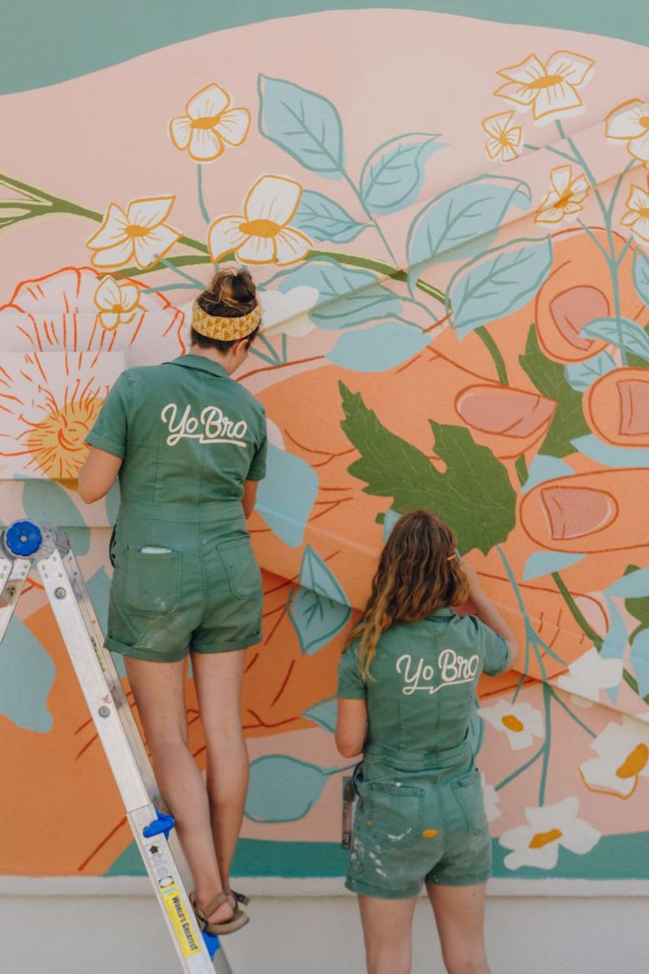 The mural team of Yo Bro works on a wall during the Sunny Dayz Mural Festival, which comes to Tulsa this week. Photo courtesy Sunny Dayz Mural Festival